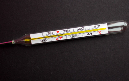 termometr with high temperature on a black background withの写真素材