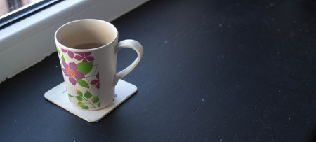 cup with tea near the windowの写真素材