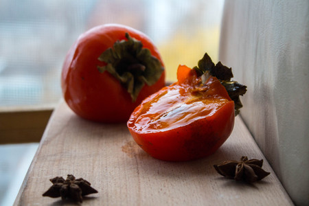 a ripe sliced persimmon on a windows backgroundの写真素材