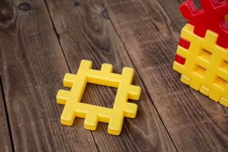 a childrens designer yellow and red on wooden backgroundの写真素材