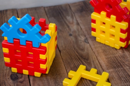 a childrens designer yellow and red on wooden backgroundの写真素材