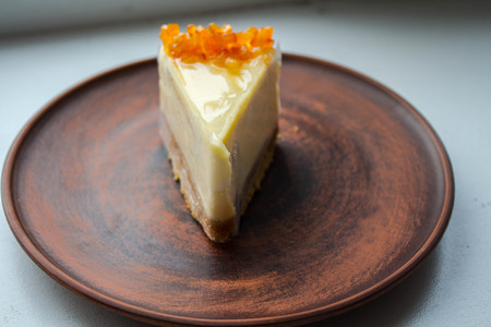 a cheesecake with candied fruit on a plateの写真素材