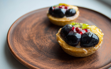 a tasty cakes with fresh fruits and berries on a plateの写真素材