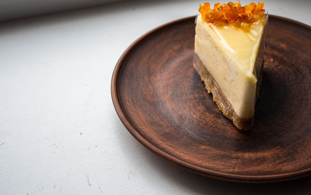 a cheesecake with candied fruit on a plateの写真素材