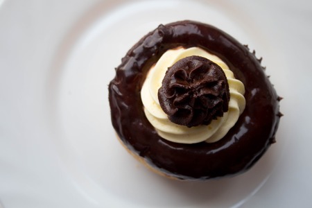 a delicious rum cake with chocolate and butter cream on a plateの写真素材