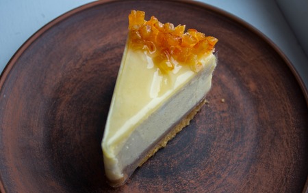 a cheesecake with candied fruit on a plateの写真素材
