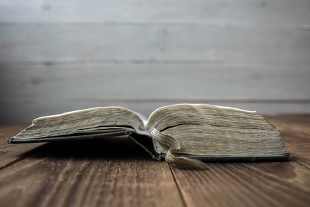a open old book on wooden backgroundの写真素材