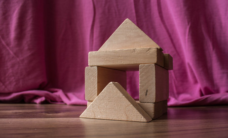 a wooden house with a childrens designer on the floorの写真素材