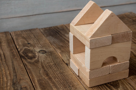 wooden house from the children's designer on wooden backgroundの写真素材