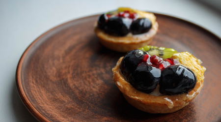tasty cakes with fresh fruits and berries on a plateの写真素材