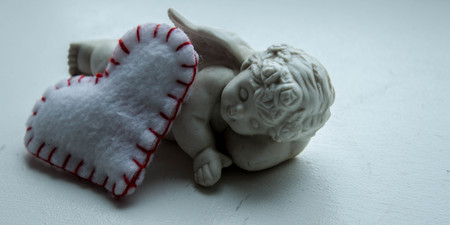 little angel with a heart on a white backgroundの写真素材