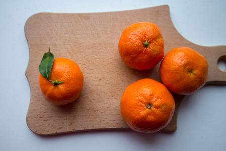 ripe tangerines on a wooden deckの写真素材