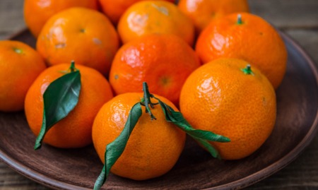 ripe tasty tangerines on a plateの写真素材