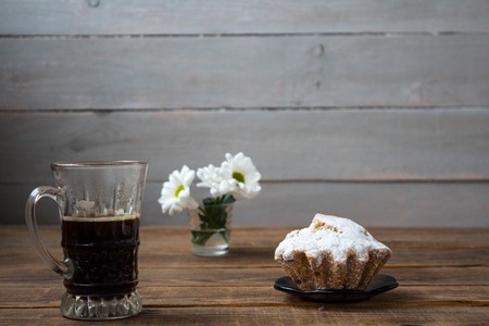 coffee cupcake and flowers on a wooden backgroundの写真素材
