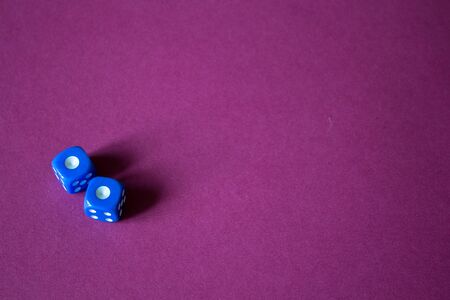 the gaming dice on a red backgroundの写真素材