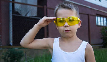 a boy in white jersey and glasses salutesの写真素材
