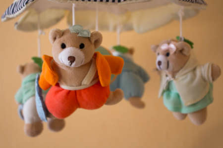 a toy for the newborn in the shape of a bear on a cribの写真素材