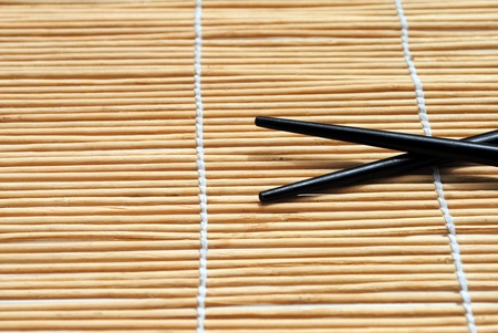 japanese chopsticks on bamboo placemat background の写真素材
