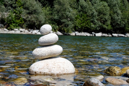 white zen stones in river waterの写真素材