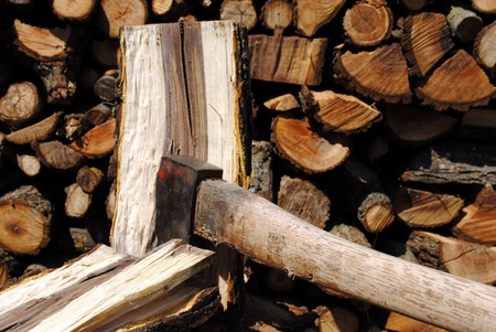 iron axe chop wood trunk with wood logs on backgroundの写真素材