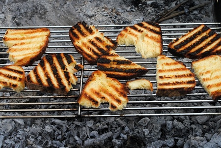 slices of grilled bread rubbed with garlic on a barbecue の写真素材
