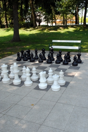 big chess set in the park with benchesのeditorial素材