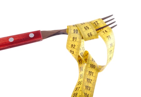 a fork with a tape measure, concept of dietの写真素材