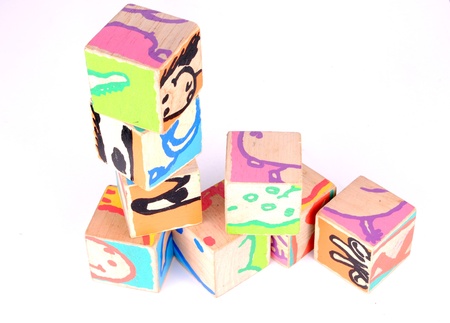 colored wooden bricks, on white background soft shadows