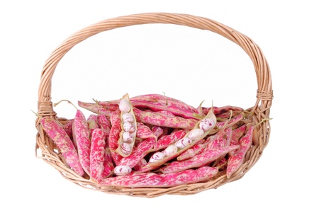purple beans in a straw basket, isolated on white background の写真素材