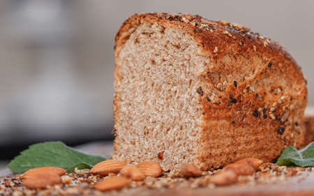 Fresh dark bread with whole wheat flour and seeds, on old wood. Copy, empty space for textの写真素材