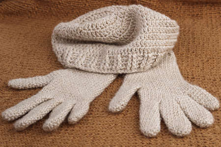 A close-up of crocheted woolen gloves and hat. Winter clothing.の写真素材