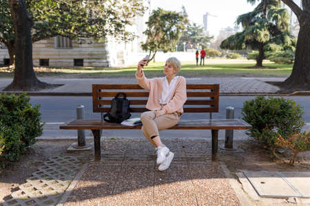 A Close-up portrait of young woman with big green eyes. Clean and healthy skin. Facial care. Sensual and penetrating look. Looking at camera. Short dyed ash blonde hair.の写真素材