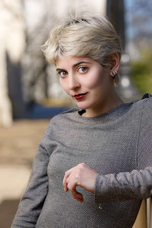 A Smile Day. Half-length portrait of a young woman smiling and looking at the camera. On a city...