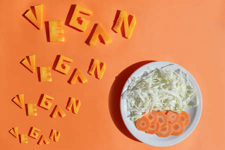 Text. Vegan. Dish with vegetables. Veganism day concept. Background for design.の写真素材