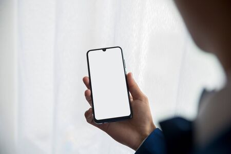 phone hand window a man holding a lightの写真素材