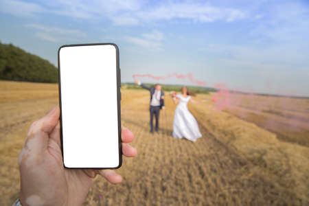 the phone is held by a hand with a violation of vitiligo pigmentationの写真素材
