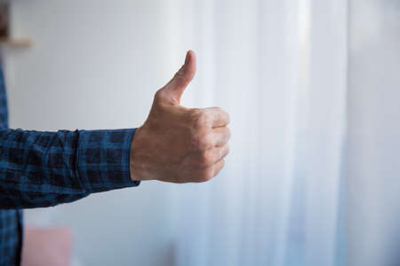 men's right hand blue shirt thumbs up photo close upの写真素材
