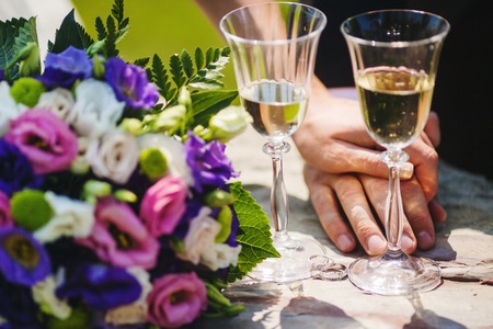 Two Gglasses with Champagne, Couple Hands, Bouquetの写真素材