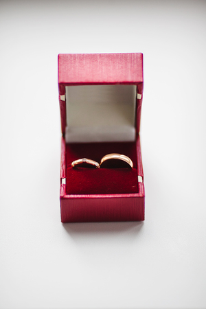 Wedding Golden Rings in red box Isolated on White.の写真素材