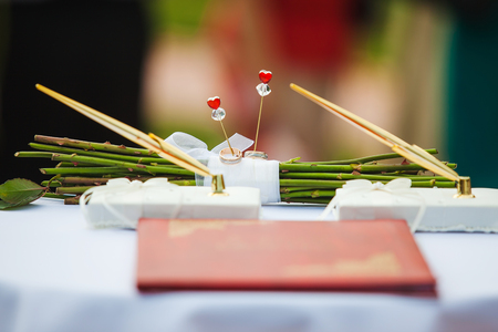 Wedding Rings on white cloth at Rose Bunch Sticks.の写真素材