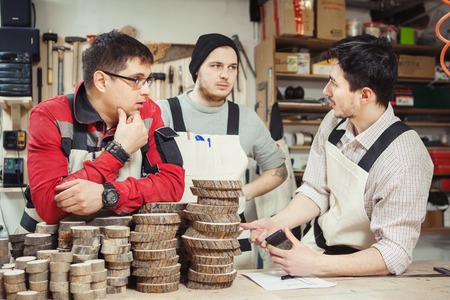 Three workers stipulated working process on wood threatmentの写真素材