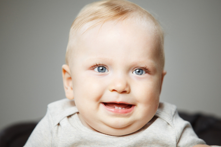 Adorable baby with plump cheeks and big eyesの写真素材