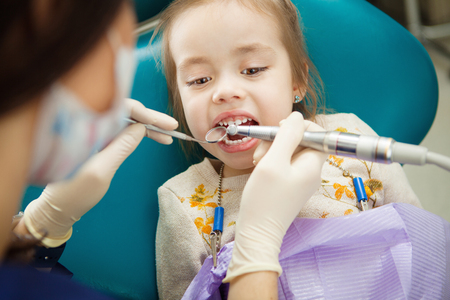 Adorable child calmly goes through procedure of teeth polishingの写真素材