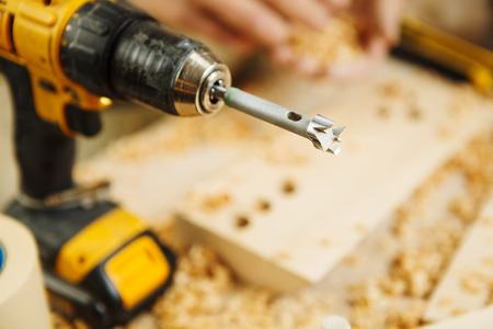 Wood boring drill closeup of electric instrument for drillling wooden surfaces