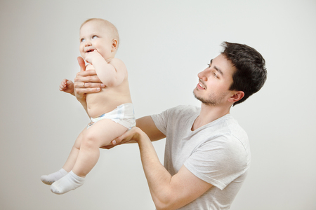 Father posing with his little son in pants and socks.の写真素材