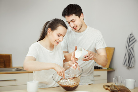 Man and woman preparing sweet dessert together. Happy coupleの写真素材