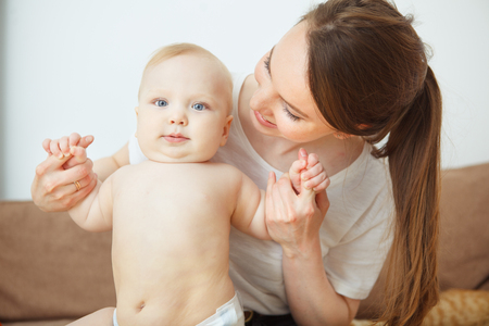 Mother takes care about her adorable infant toddler, happy motherhoodの写真素材