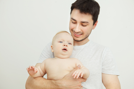 Smiling father posing with his little son. Adorable baby boyの写真素材