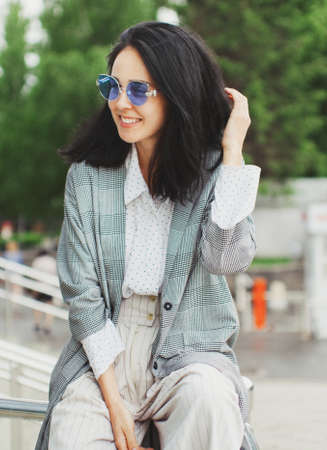 portrait of smiling woman in blue spectacles and fancy clothes. shot girl in a stylish and loose attire.の写真素材