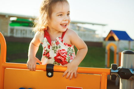 little happy girl playing on playground.の写真素材